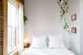 White bedroom area with hanging plant