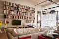 A living room with a large bookcase filled with books.