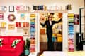 Man standing in doorway with colorful books in white space