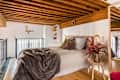 Bed with decorative pillows and blankets.