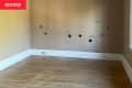 empty brown bedroom with wood floor before remodel