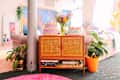 Cakes top caned console in colorful living room.