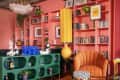 colorful living room with floor to ceiling coral shelves