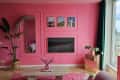 Pink living room with pink shag area rug, art, large windows
