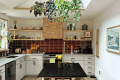 Kitchen with skylight and plants and dark rust backsplash tiles