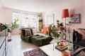 Eclectic living room of plant filled apartment.