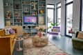 Large shelving unit anchors pastel living room on houseboat.