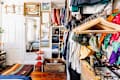 Bedroom with exposed clothing rack.