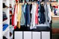 Clothing hangs in an exposed closet.