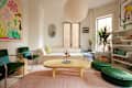 White living room space with colorful furniture