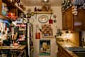 White kitchen space with kitchenware and items on walls