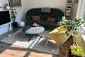 Green couch with yellow chair in living room space