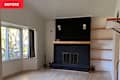 Black painted brick fireplace in living room before renovation.