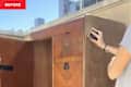 Person sanding vintage cabinet