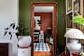 wood trim doorway looking into a dining room with plaid rug