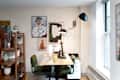 Large wall lamp hanging above desk in home office.