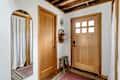 Wood doors in white entryway