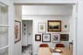 Framed art on white wall in dining room. Gallery wall.
