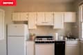 Rental kitchen with white cabinets and tan walls
