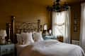 Black chandelier in gold painted bedroom.