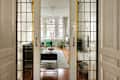 Stained glass on doors before white living room