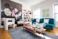 Blue couch and artwork on walls in white living room