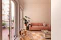 Pink couch in white living room