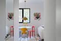 Colorful chairs at table in white space