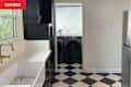 White and black basic kitchen with checkered floor before makeover