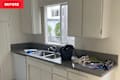 Clutter on counter in white kitchen before redecorating.