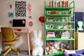 Colorful home office with a green bookshelf, computer desk, decorative items, and a large white bunny figure.