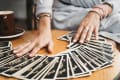 Woman is reading Tarot cards on the table in cafe