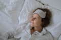 Woman smiling alone in bed