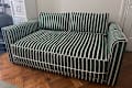 Striped Sabai sleeper sofa in living room.