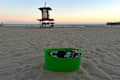 IKEA TORKIS basket full of beach supplies on the beach at sunset
