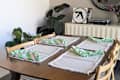 Green and white ruffled napkins on set dining table.