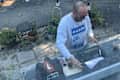 Someone using a vintage typewriter outside.