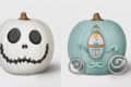 White pumpkin with Jack Skellington face and blue pumpkin styled as Cinderella's carriage.