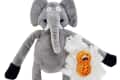 Gray elephant plush toy with stuffing exposed, revealing a small orange peanut character inside.