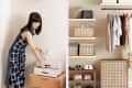 Woman organizing a drawer next to a closet with neatly arranged clothes, shoes, and storage baskets.