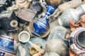 Assorted vintage items including blue floral vases, metal pots, and wooden boxes at a flea market.