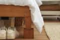 head on shot of a wooden bed frame using a wooden bed riser.