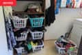Clothes in laundry baskets before organizing.