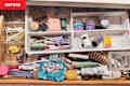 Messy toiletry drawer in bathroom.