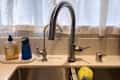 The Delta Trinsic Touch2O Technology Kitchen Faucet installed in someone's kitchen sink