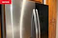 Fridge being cleaned with Weiman Stainless Steel Cleaner, streaks on front