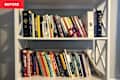 Books disorganized on bookshelf.