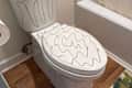Marker drawn on toilet seat.