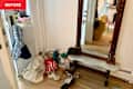 Shoes and bags in entryway before organizing.