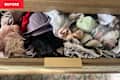 A cluttered drawer filled with various bras, lace items, and socks in different colors and textures.